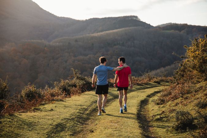 Sportive males taking break after running in mountains