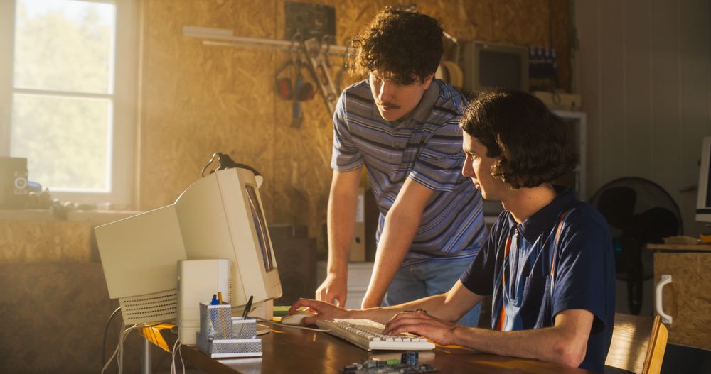 Two White Male Tech Startup Founders Using Old Desktop Computer In Retro Garage.