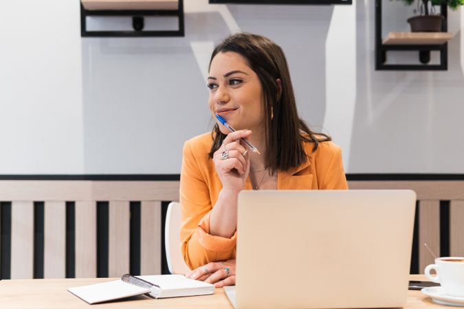 Content woman working on project in cafe