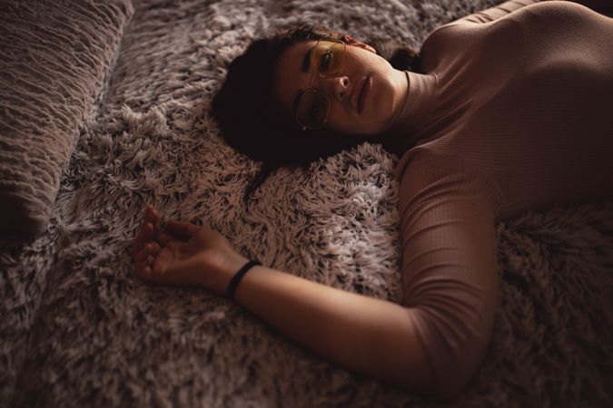 Young woman lying on bed