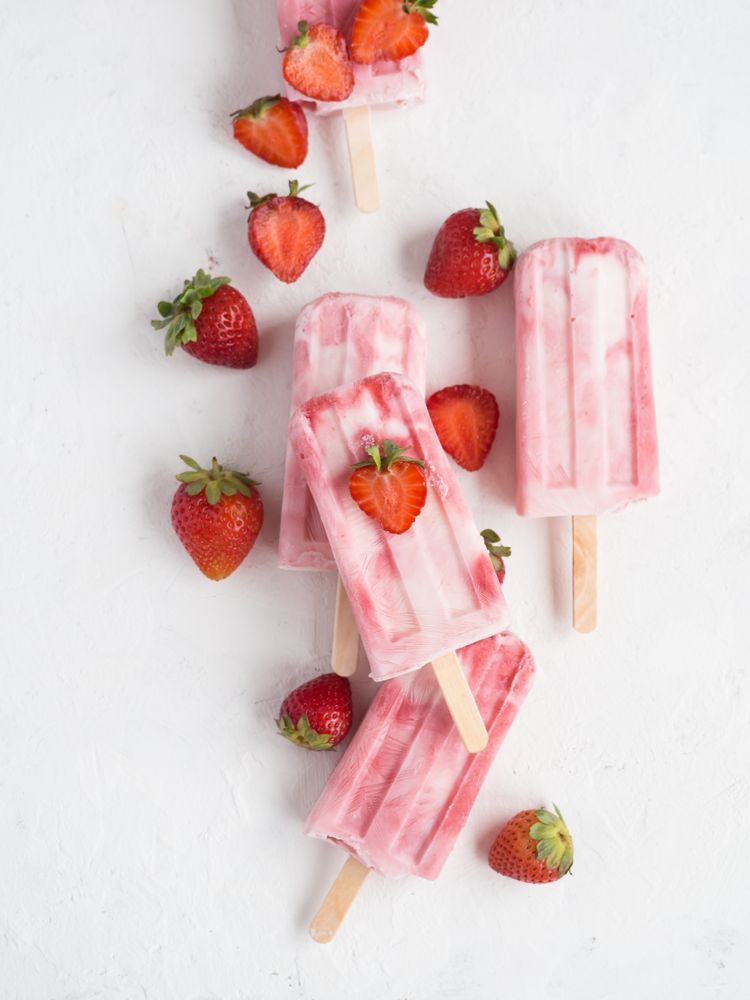 Pink popsicles and fresh strawberries