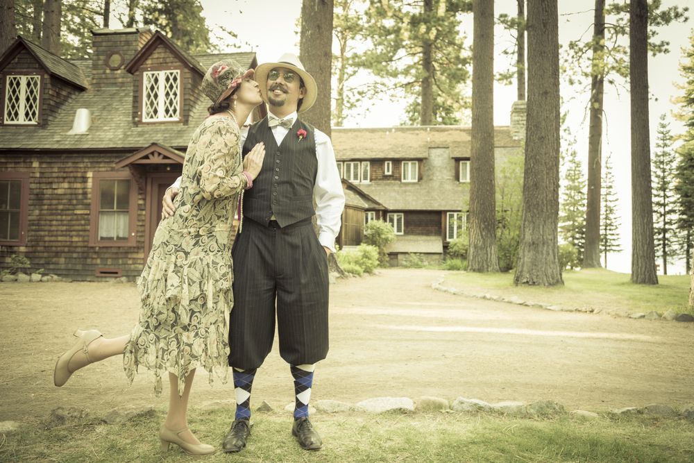 Affectionate Dressed Romantic Couple in Front of Old Cabin
