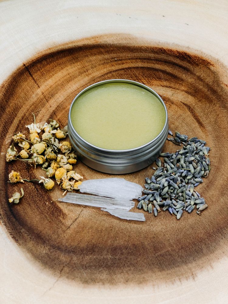 Pot of cannabis salve with herbs