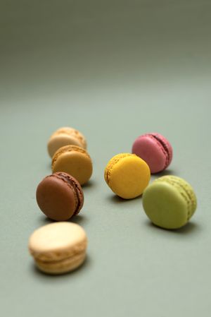 Pastel macaroon desserts on a marble background