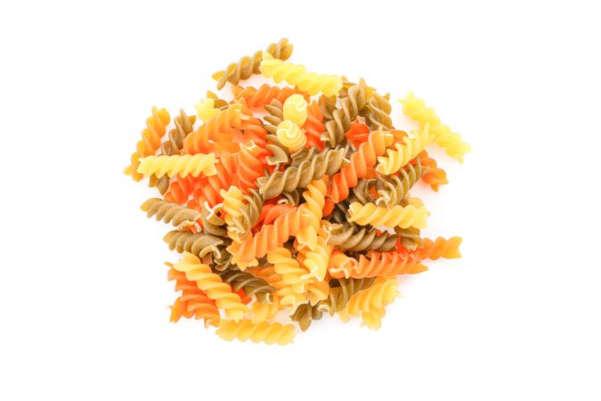 Pasta isolated on bright background, top view. Shape of dry uncooked whole pasta