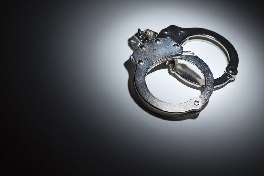 Abstract Pair of Handcuffs Under Spot Light - Text Room