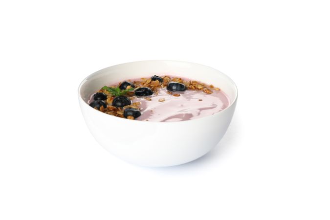 Yogurt with granola, blueberry and mint isolated on plain background