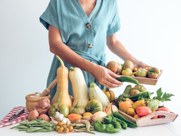 Woman with ripe fresh vegetables