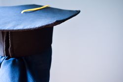 Back of person wearing graduation cap in studio shoot