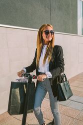 Woman with shopping bags on electric scooter