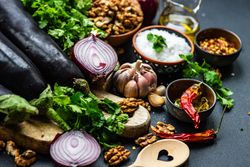 Ingredients for cooking eggplant dish on rustic background
