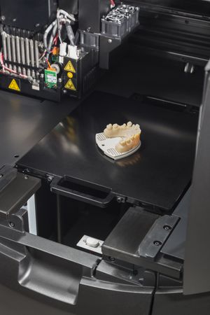 3D Printer With Finished 3D Printed Dental Implant Bridge