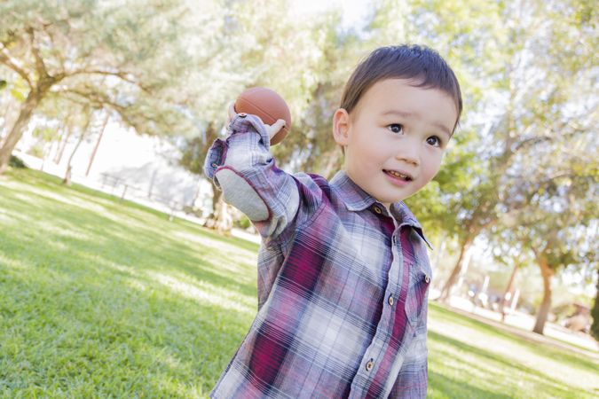 Boy Playing Football Outside