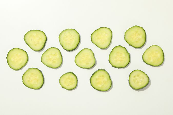 Cucumber slices on blank background, top view