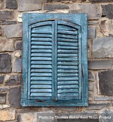 Vintage exterior shutters on aged stone wall 42B9g4