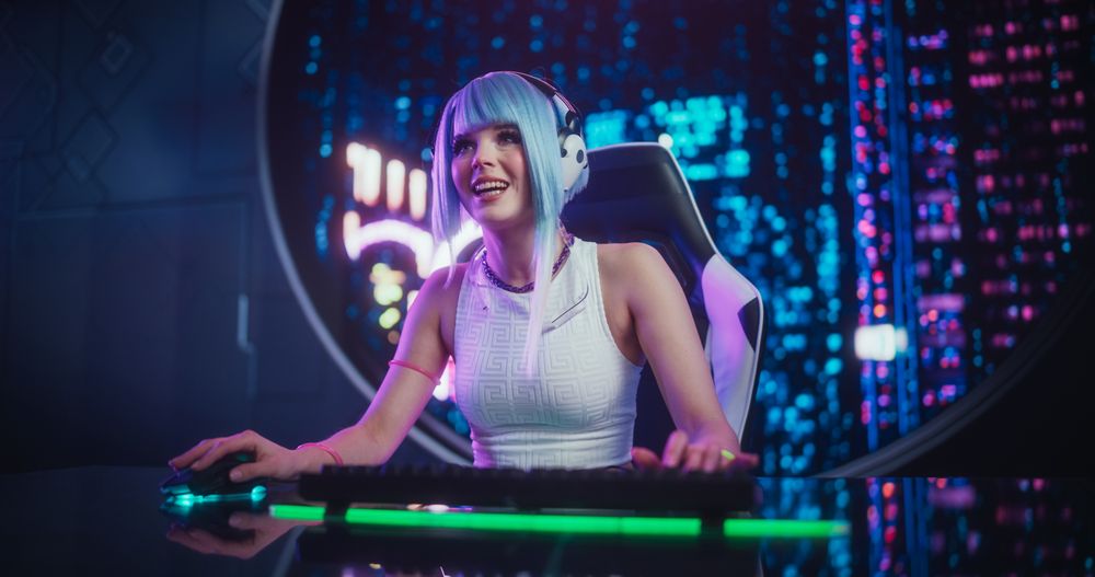 Stylish Streamer or Gamer with Blue Hair Chats with Internet Fans on Computer in Futuristic Cyber Technology Room.