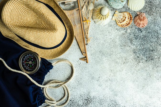 Summer background with hat, compass and seashells
