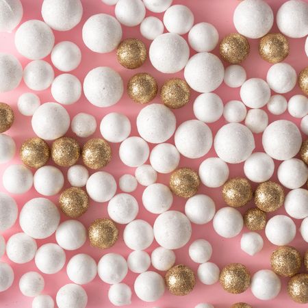 Christmas pink background made of gold and glitter ball decoration