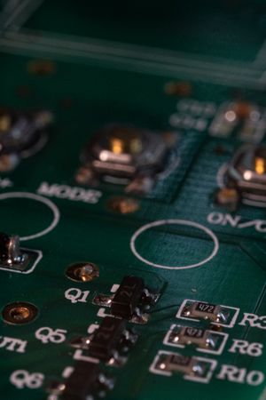 Green PCB with various electronic components soldered in place