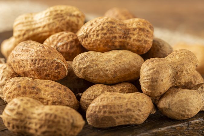 Dry peanut on the wooden background.