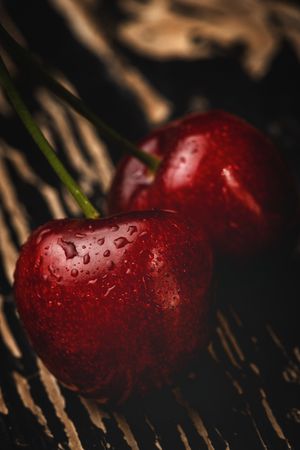 Red ripe cherry with stem on wooden stand