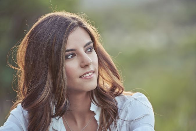 Dreamy woman sitting in nature