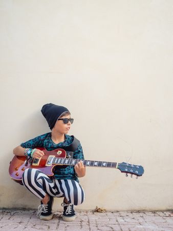 Energetic kid holding guitar