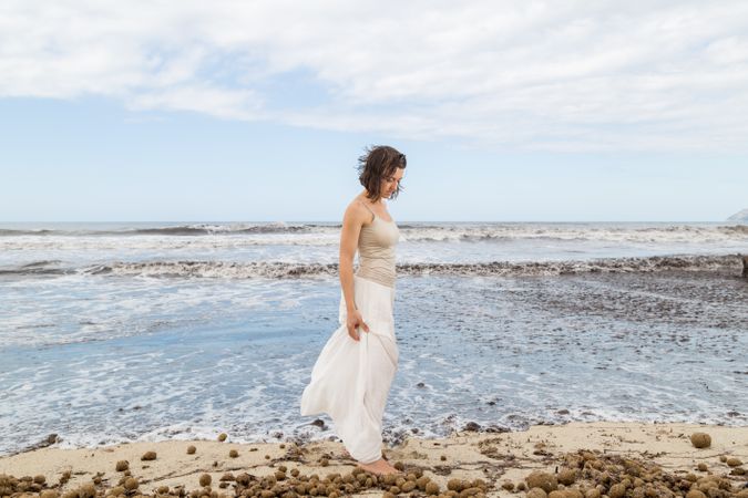 Charming young woman on shore near water
