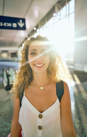 woman walking in spacious hall in sunlight