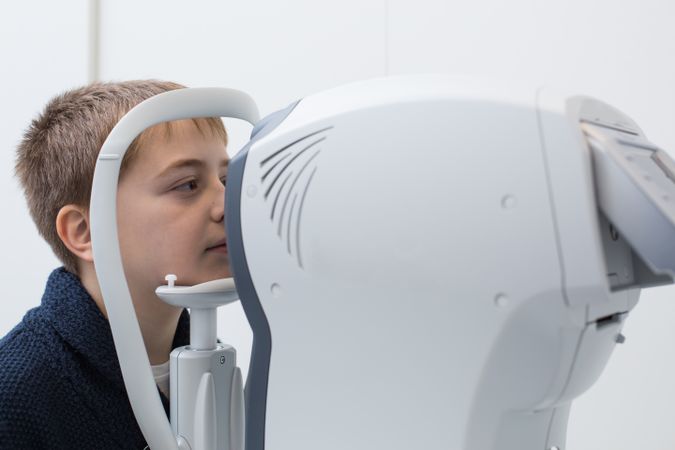 Optician testing a boy's eyes