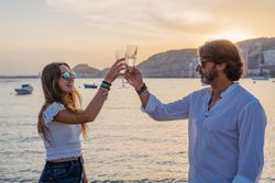Happy family drinking wine on beach