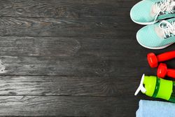 Flat lay composition with healthy lifestyle accessories on wooden background