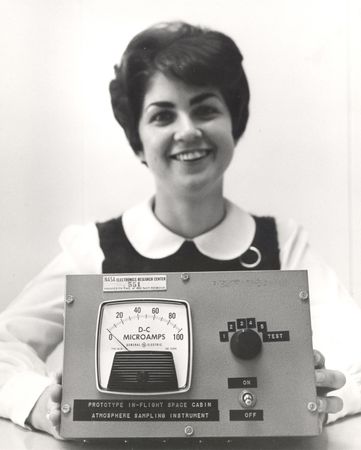 The Aerosol Particle Analyzer, held by Theresa Thibodeau, flew on one of the Apollo earth orbital