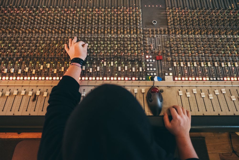 Man in a equalizer instrument in a studio
