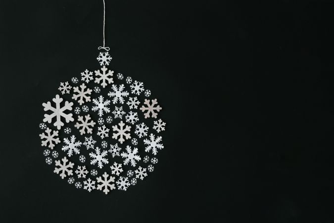 Christmas bauble or ball decoration made of snowflakes on dark background