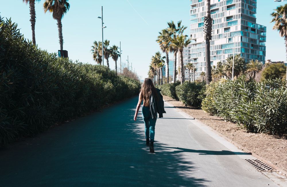 Teen girl walking happily through the streets.