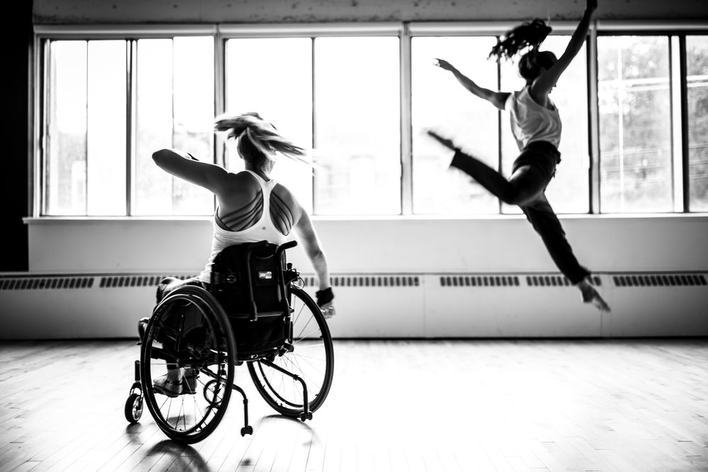 MONTREAL, QUEBEC, CANADA – August 29 2018- One woman in a wheelchair, another woman leaping