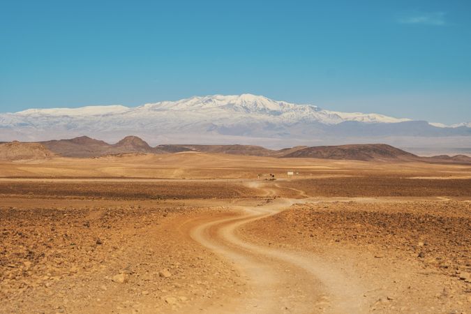 Road between desert and blue sky