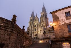 Santiago de Compostela Cathedral view at misty foggy night after rain. Cathedral of Saint James pilgrimage. Galicia, Spain
