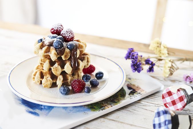 Served waffles with topping and berries