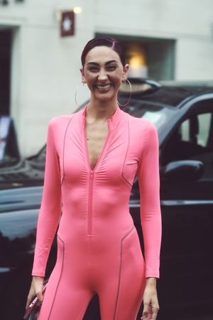 London, England, United Kingdom - September 18 2021: Smiling woman in pink jumpsuit