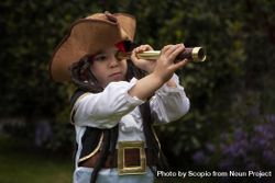 Girl wearing pirate outfit and holding a telescope 0PmPv5