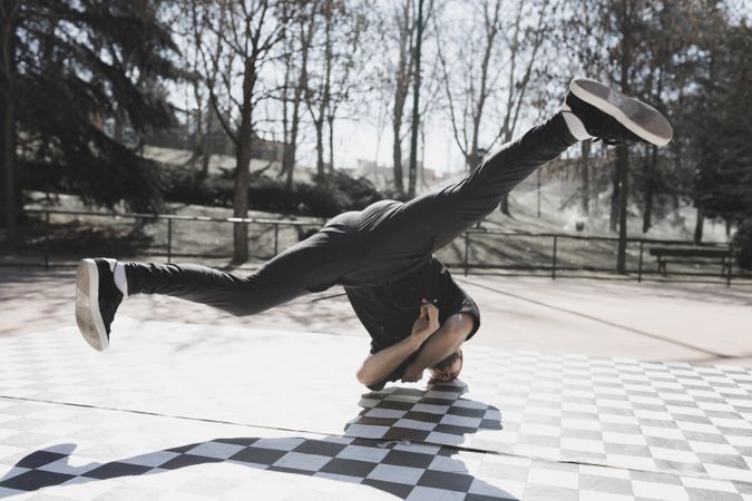 Man dancing break dance in park