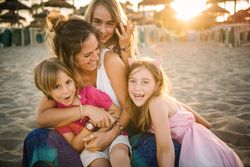 Playing woman with kids on beach