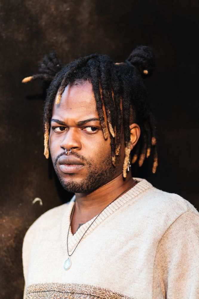 Stylish Black man with dreadlocks in buns
