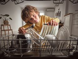 Boy with instruments checking dishwasher