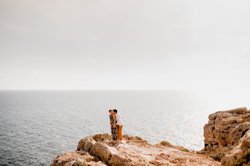 Couple embracing on rock