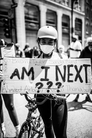 MONTREAL, QUEBEC, CANADA – June 7 2020- Woman with bike and helmet at protest