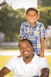 Happy Father and Son Standing In the Sun
