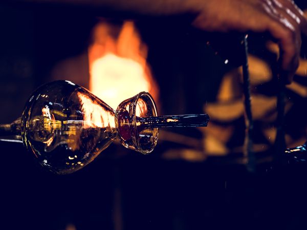 Transparent glass bottle near fire